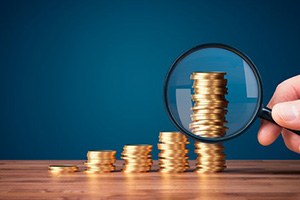 Coins examined with magnifying glass