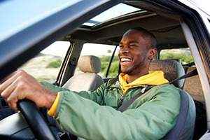 Man smiles while driving