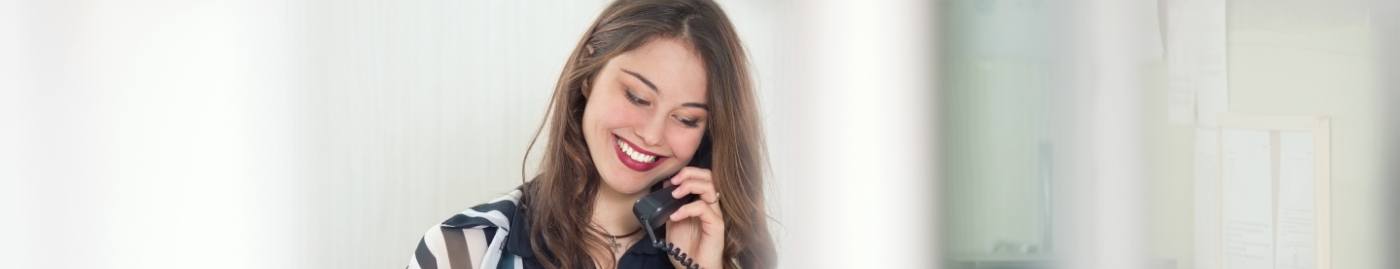 Dental team member smiling while talking on phone