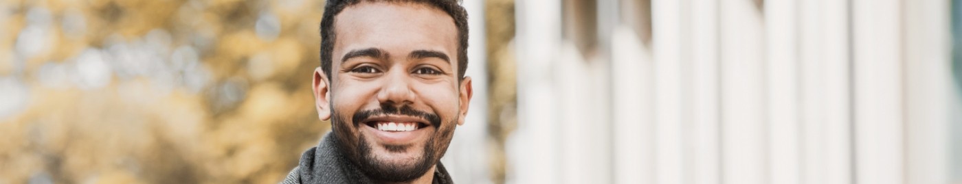 Smiling man in gray jacket
