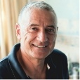 Smiling older man in navy blue polo shirt
