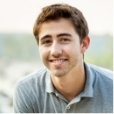 Smiling young man in light gray polo shirt