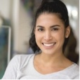 Smiling young woman in white blouse