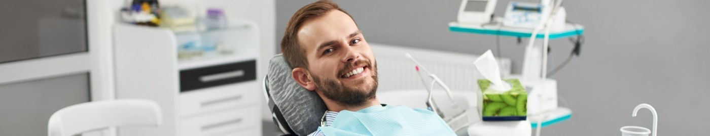 Smiling man leaning back in dental chair
