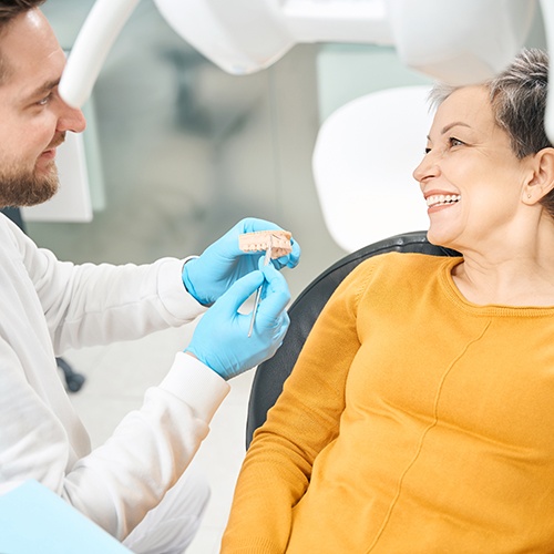 Patient smiling at dentist during dental implant consultation
