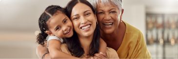 Young girl smiling with her mother and grandmother