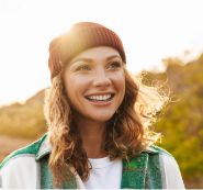 Woman in beanie smiling outdoors