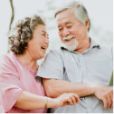 Senior couple smiling at each other and holding hands