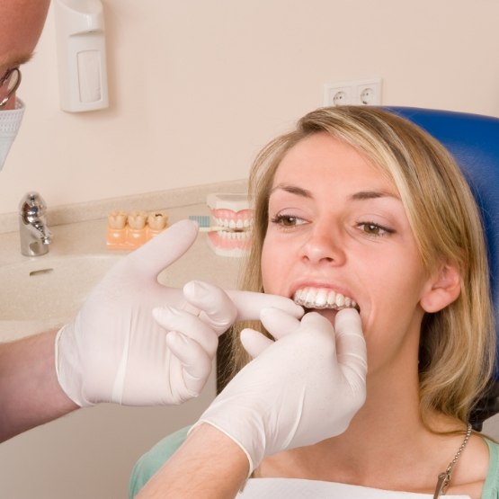 Dentist fitting a patient with Invisalign aligners