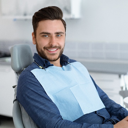 Man in dental chair showing teeth after smile makeover in Albuquerque