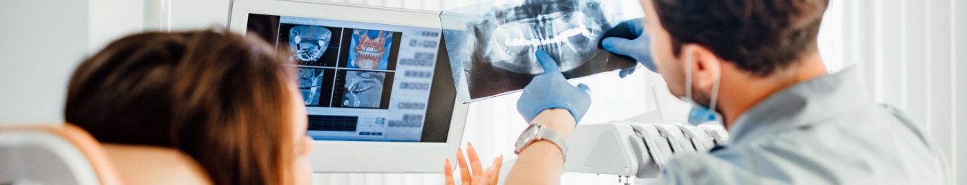 Dentist showing a patient an x ray of their teeth