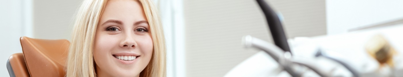 Blonde woman smiling during preventive dentistry checkup in Albuquerque
