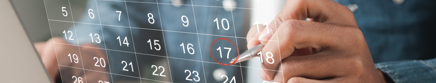 Person circling date of dental appointment on calendar