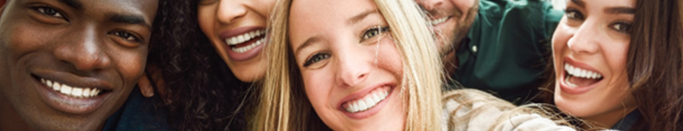 Group of friends smiling after teeth whitening in Albuquerque 
