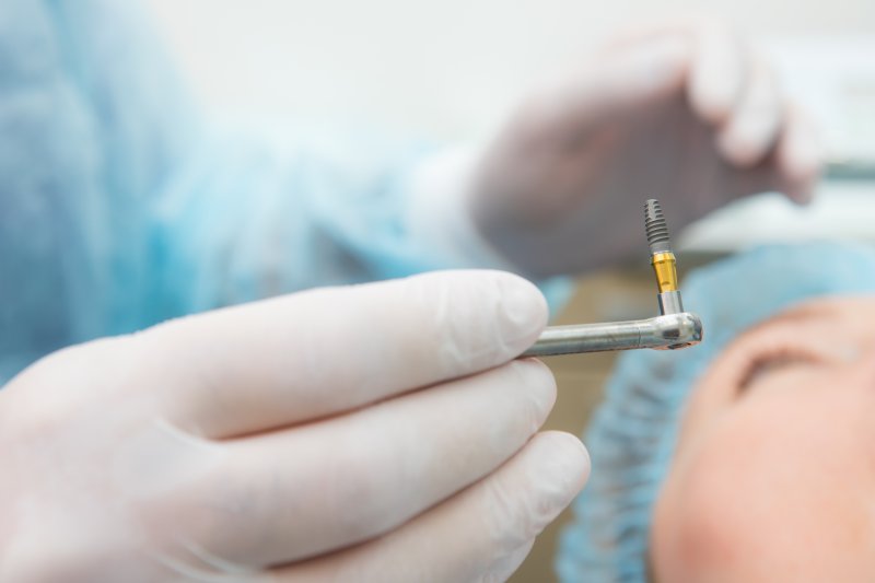 up-close view of a dental implant in a dentist’s hand