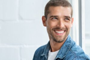 Middle-aged man looking younger after cosmetic dental work
