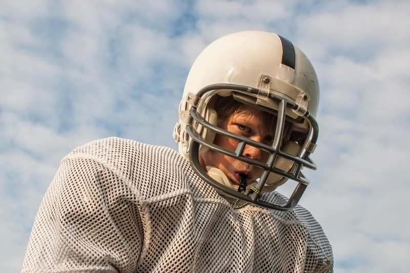 Teen patient playing football with braces