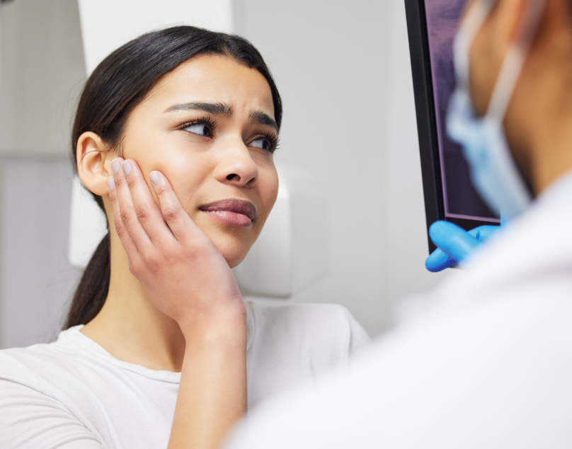 Patient holding jaw in pain